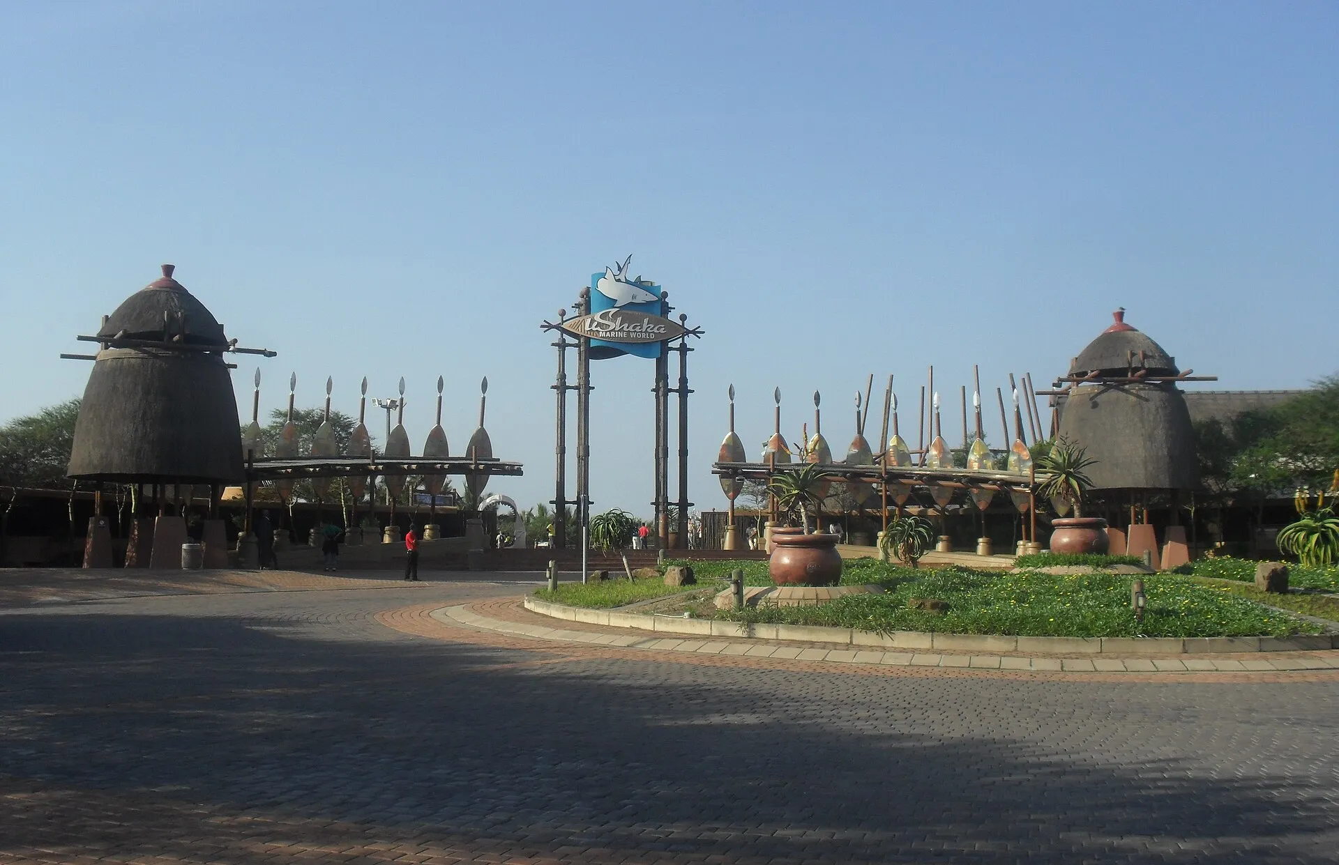 Entrance of uShaka Marine World in Durban with Zulu-inspired thatched towers, shields and the park's shark logo sign