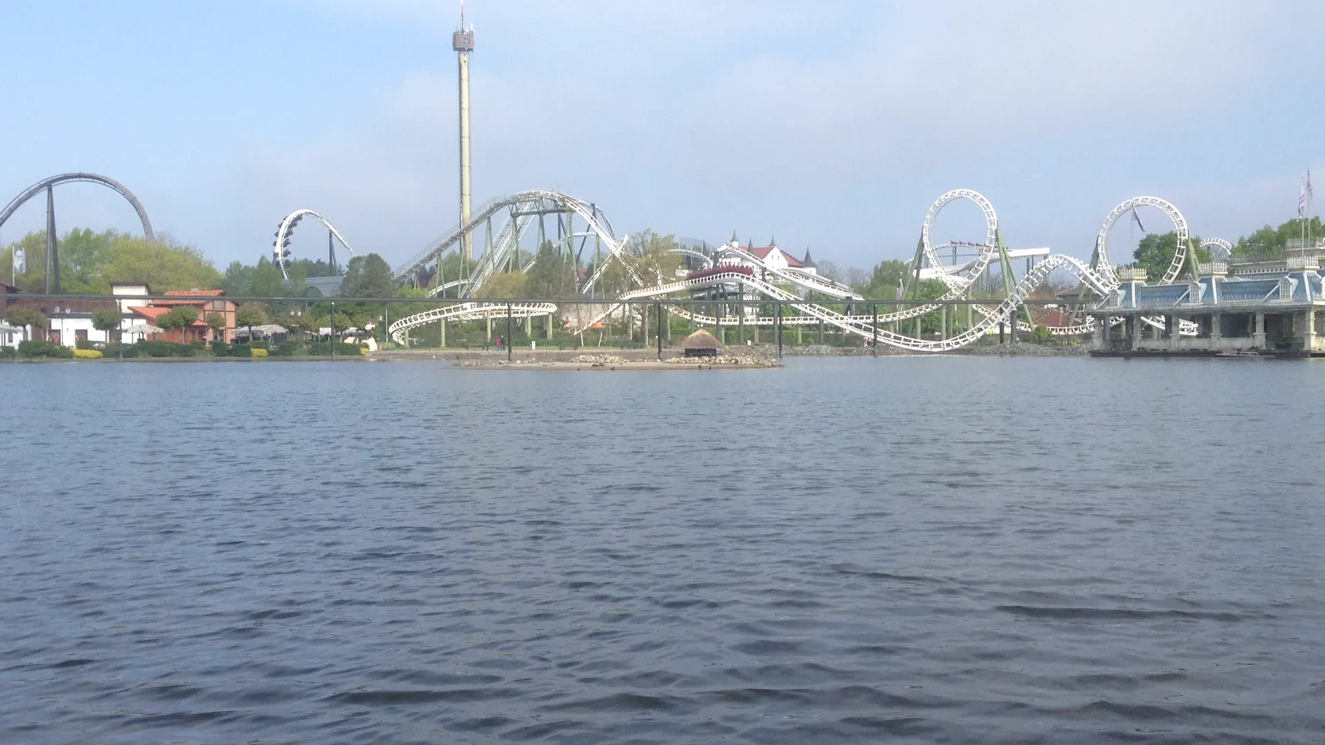 Panorama of Heide Park Soltau across the lake with roller coasters and observation tower