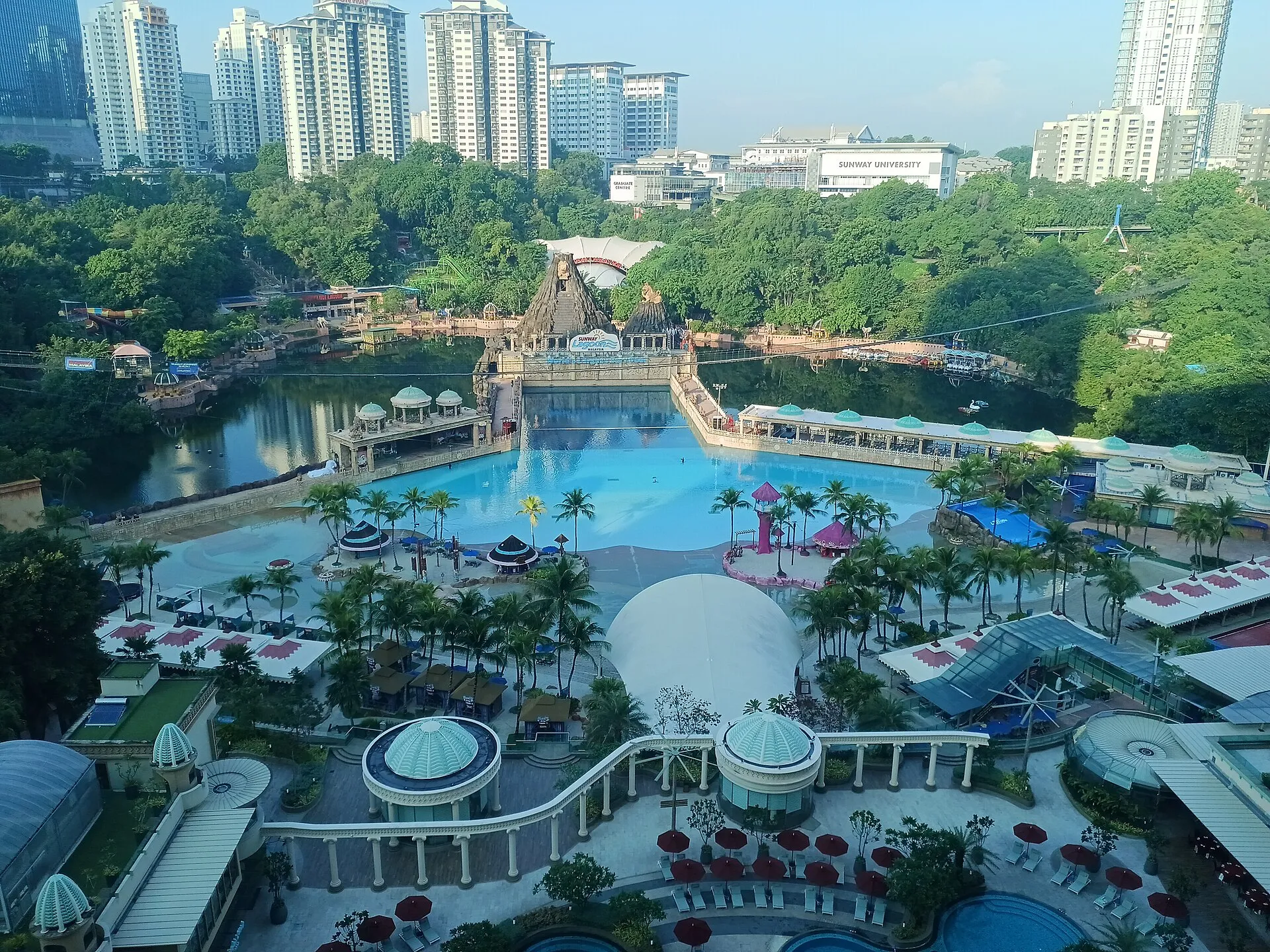 Panorama of Sunway Lagoon's surf beach wave pool and water park with the Kuala Lumpur suburb skyline behind