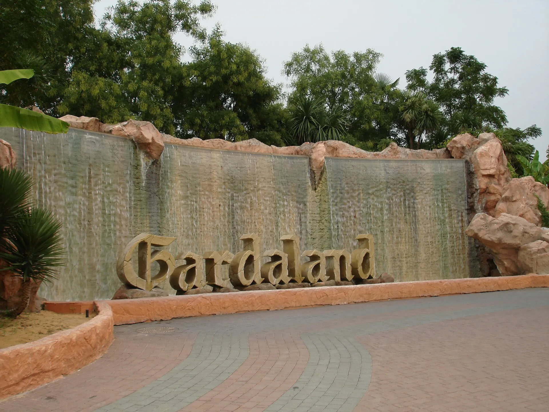 Waterfall fountain with the Gardaland sign at the park entrance in Castelnuovo del Garda