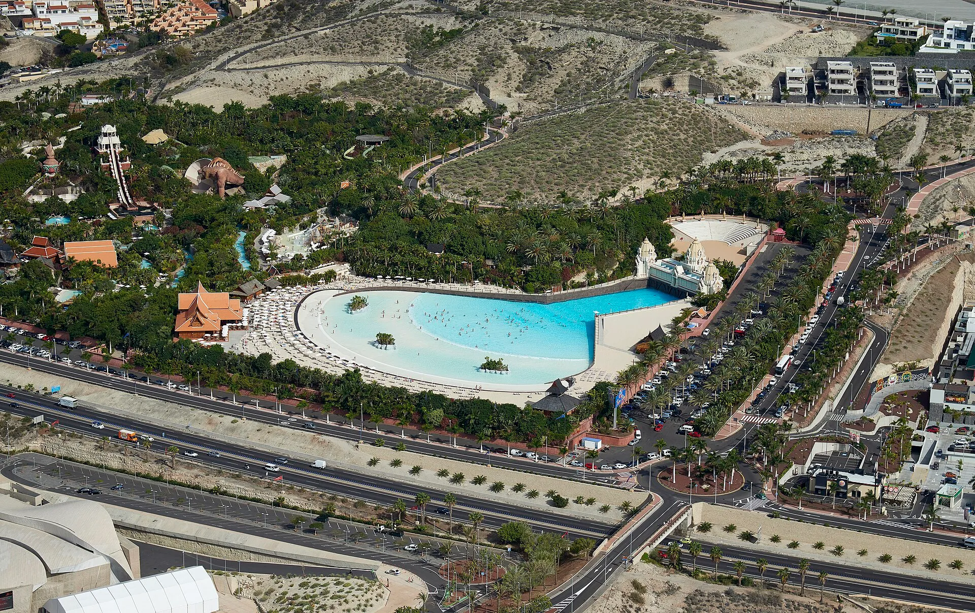 Aerial view of Siam Park in Costa Adeje, Tenerife, showing the wave pool, white-sand beach and Thai-themed buildings