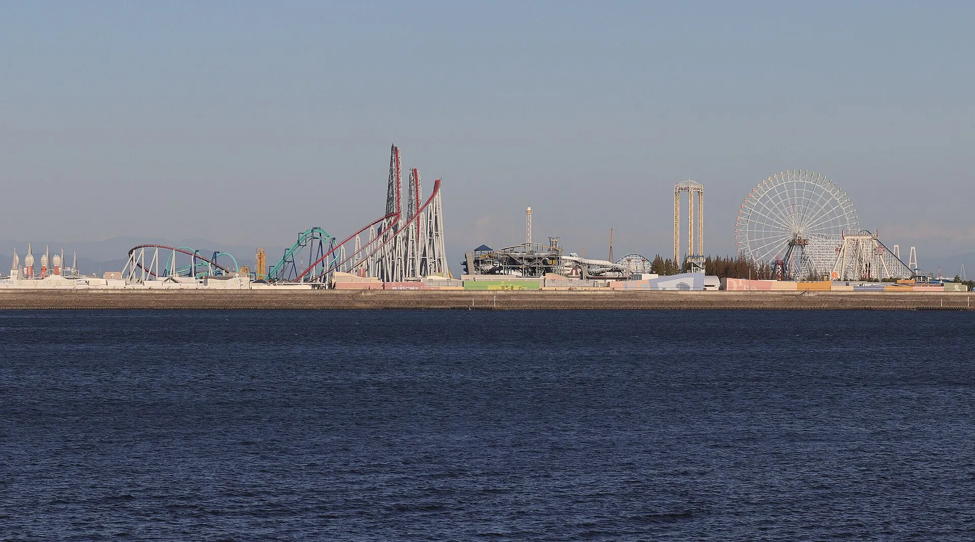 Nagashima Spa Land skyline across the water with Steel Dragon 2000, Hakugei and the Aurora Wheel ferris wheel