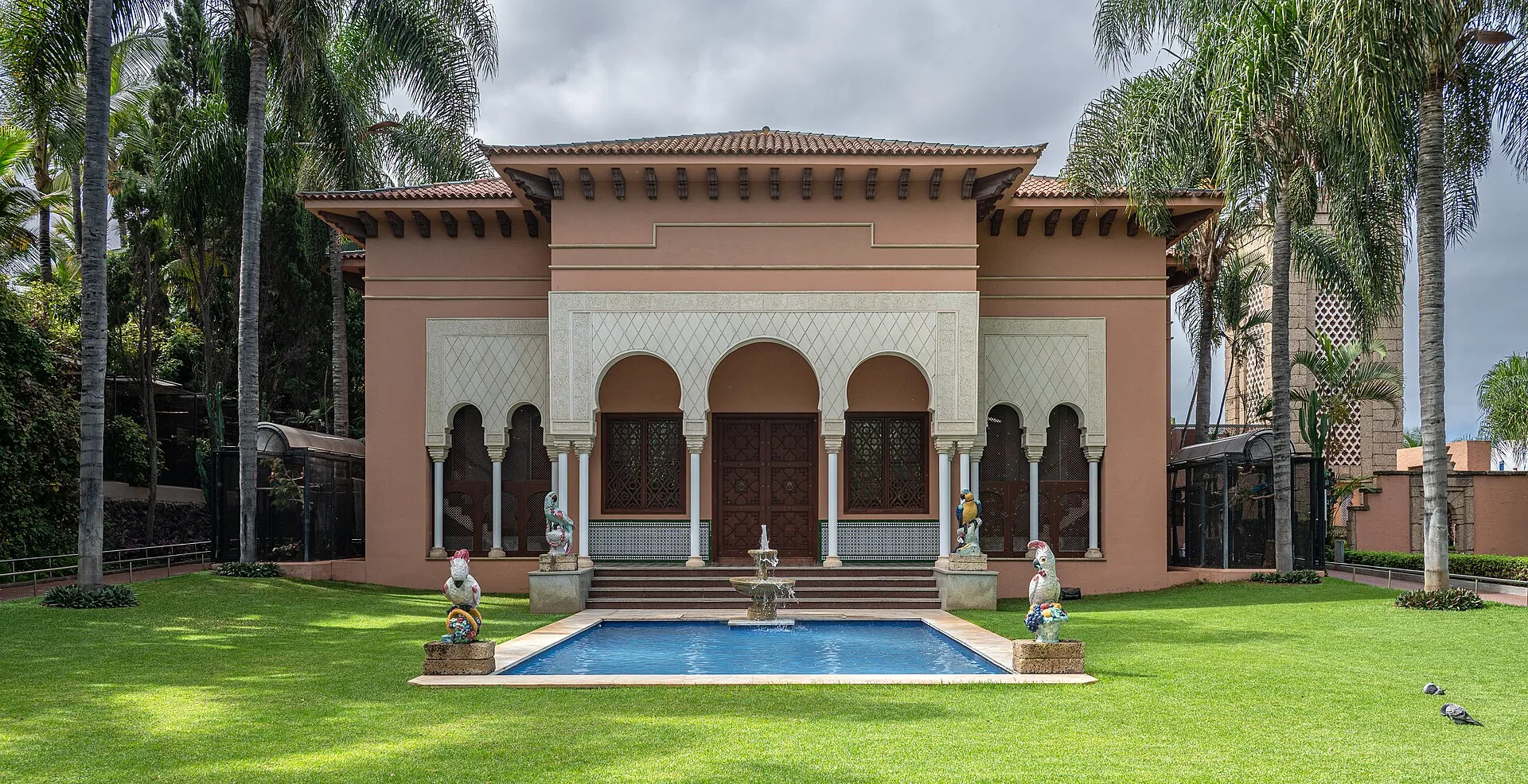 Thai-style show building with fountain and palm trees at Loro Parque, Puerto de la Cruz, Tenerife