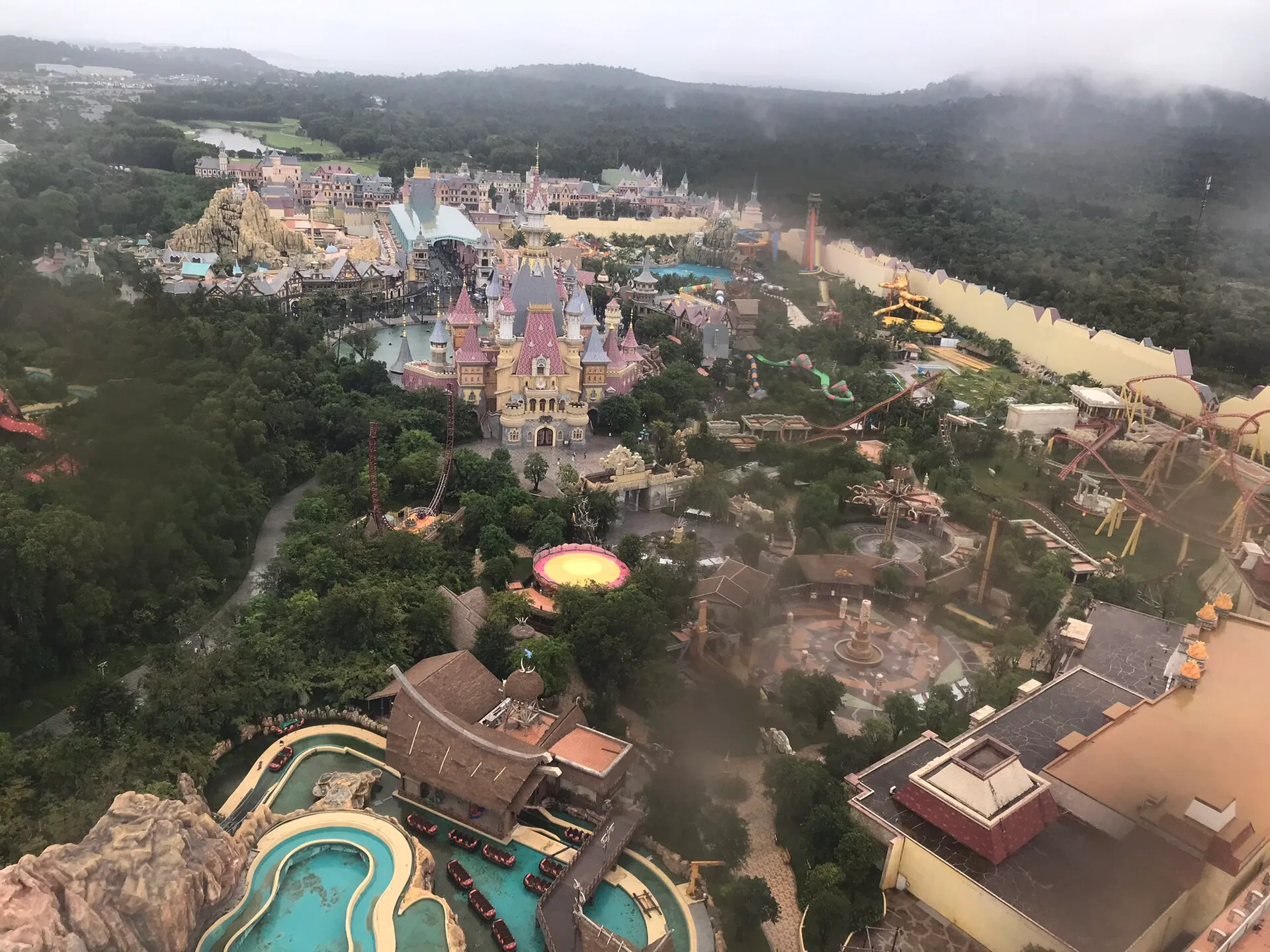 Aerial view of VinWonders Phu Quoc with its fairy-tale castle, coasters and water park seen from the ferris wheel