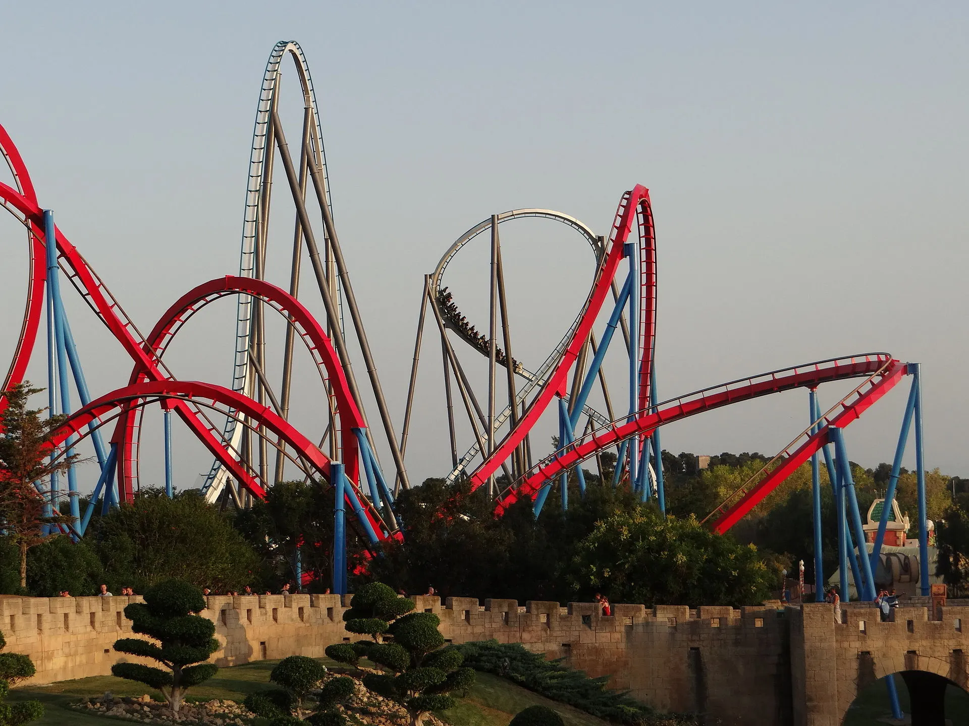 Shambhala and Dragon Khan roller coasters intertwined above the trees at PortAventura Park, Salou