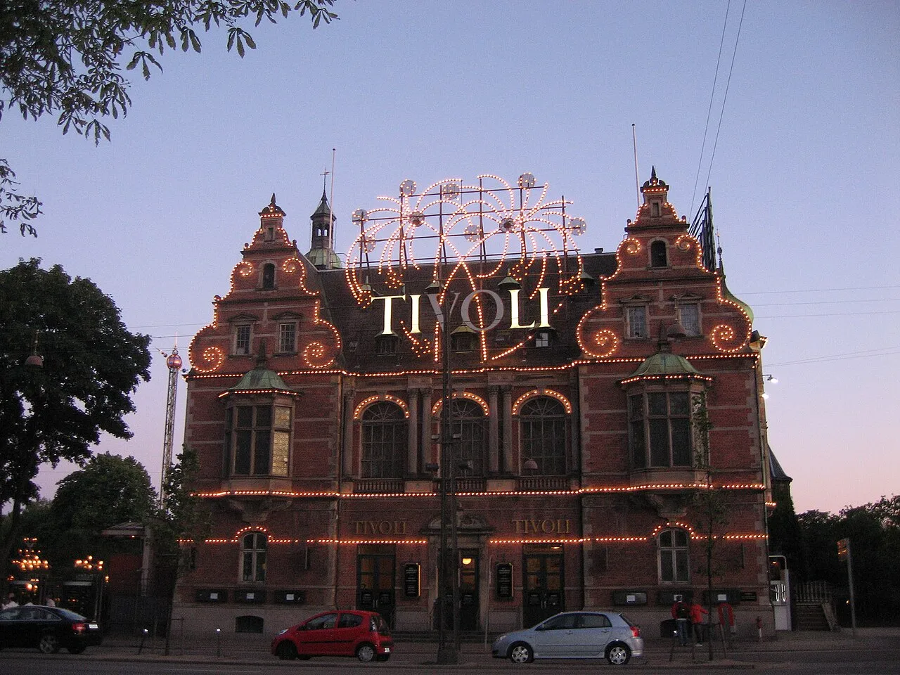 Illuminated main entrance building of Tivoli Gardens in Copenhagen at dusk