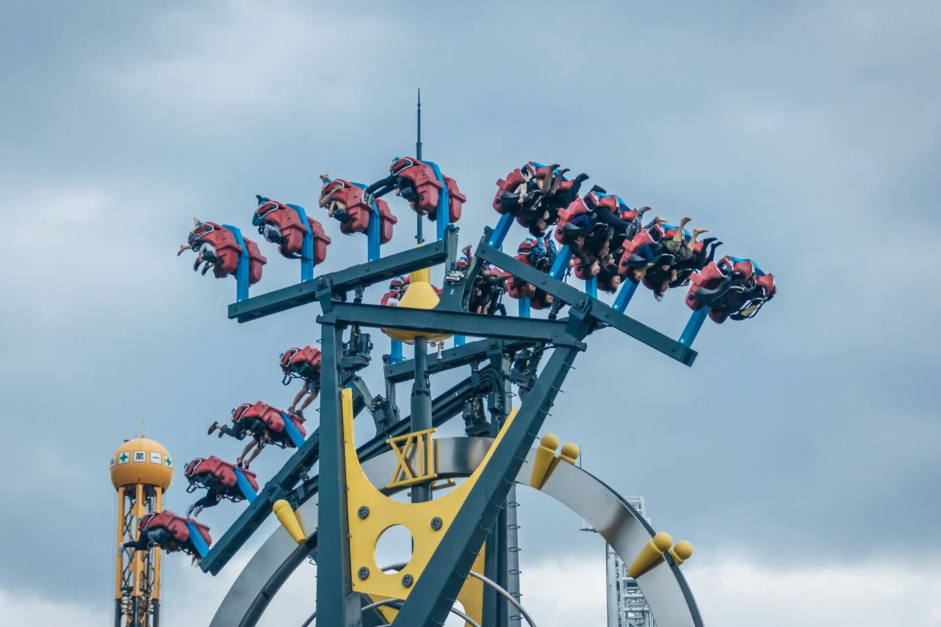 Riders on the Eejanaika 4th-dimension roller coaster at Fuji-Q Highland with seats rotated mid-air