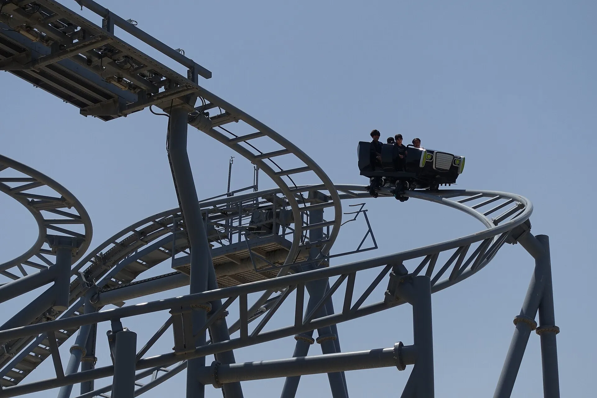 The Green Hornet: High Speed Chase roller coaster at Motiongate Dubai with riders cresting a turn