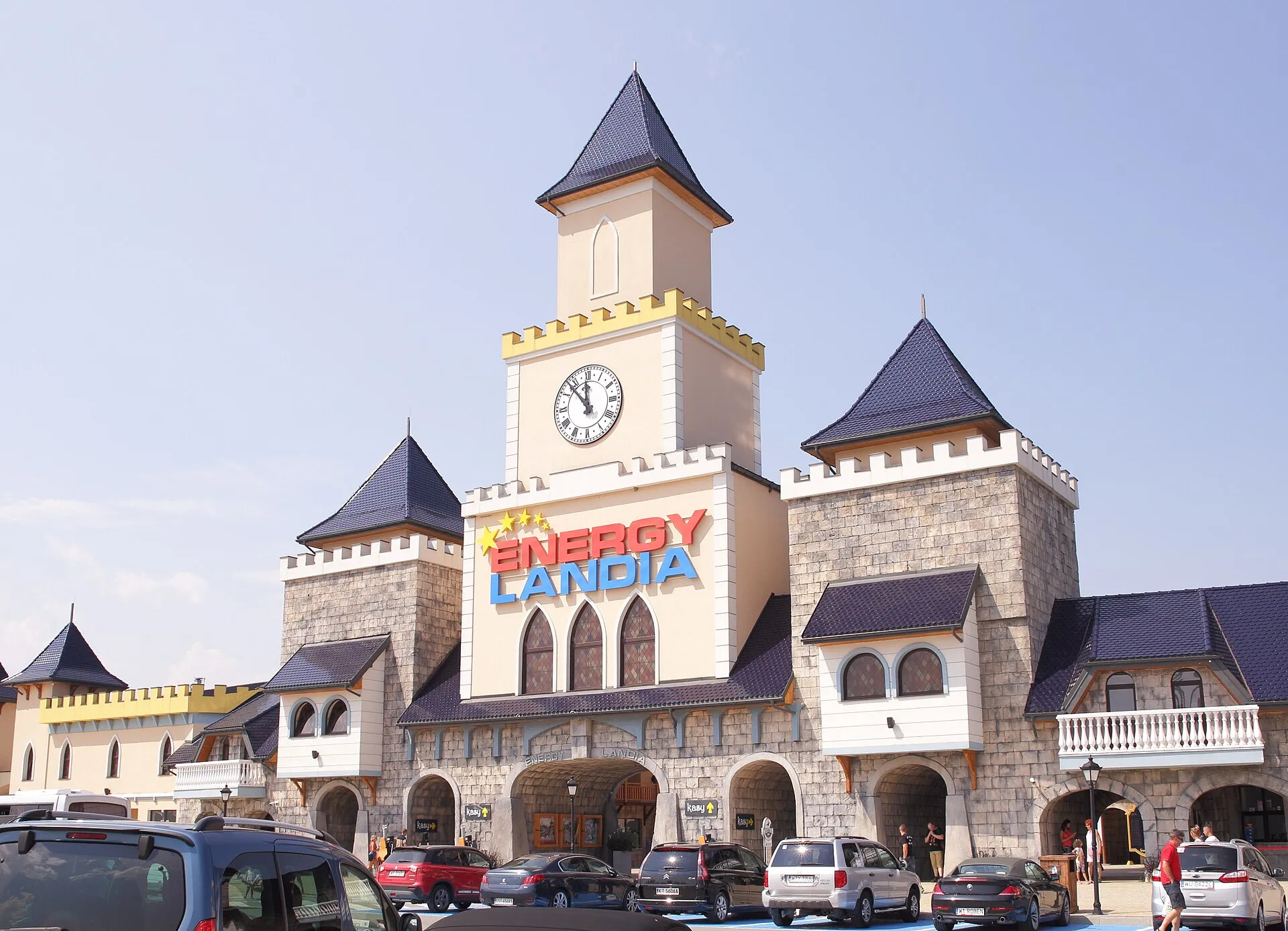 Castle-style main entrance gate with clock tower at Energylandia in Zator, Poland