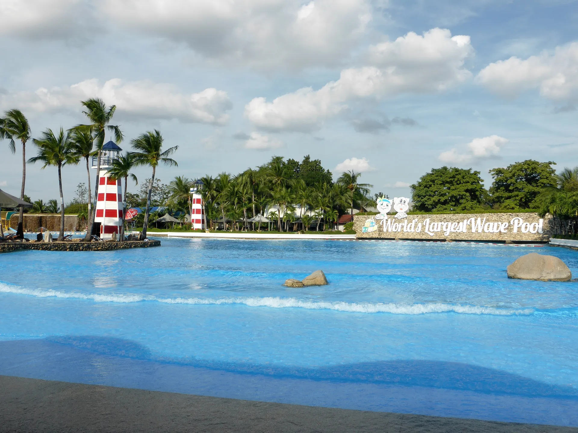 Giant wave pool at Siam Amazing Park Bangkok with lighthouse towers and World's Largest Wave Pool sign